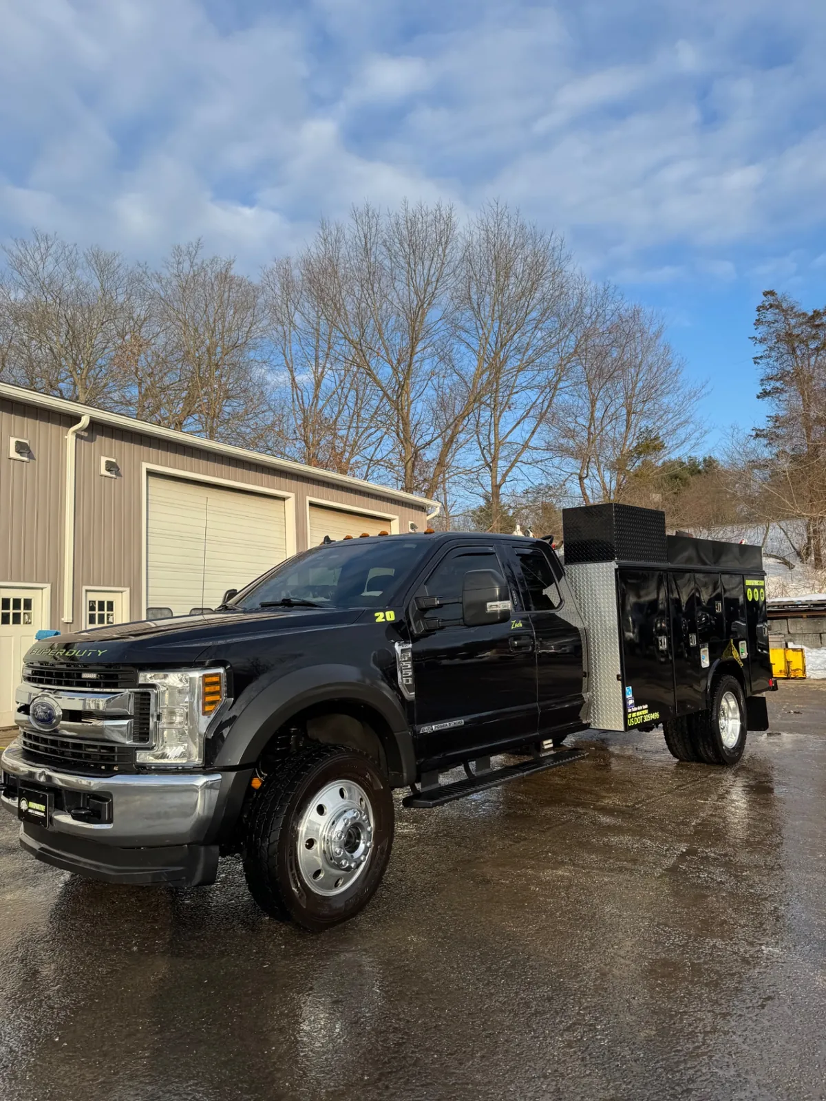 Clean polished black utility truck after hot-water fleet washing