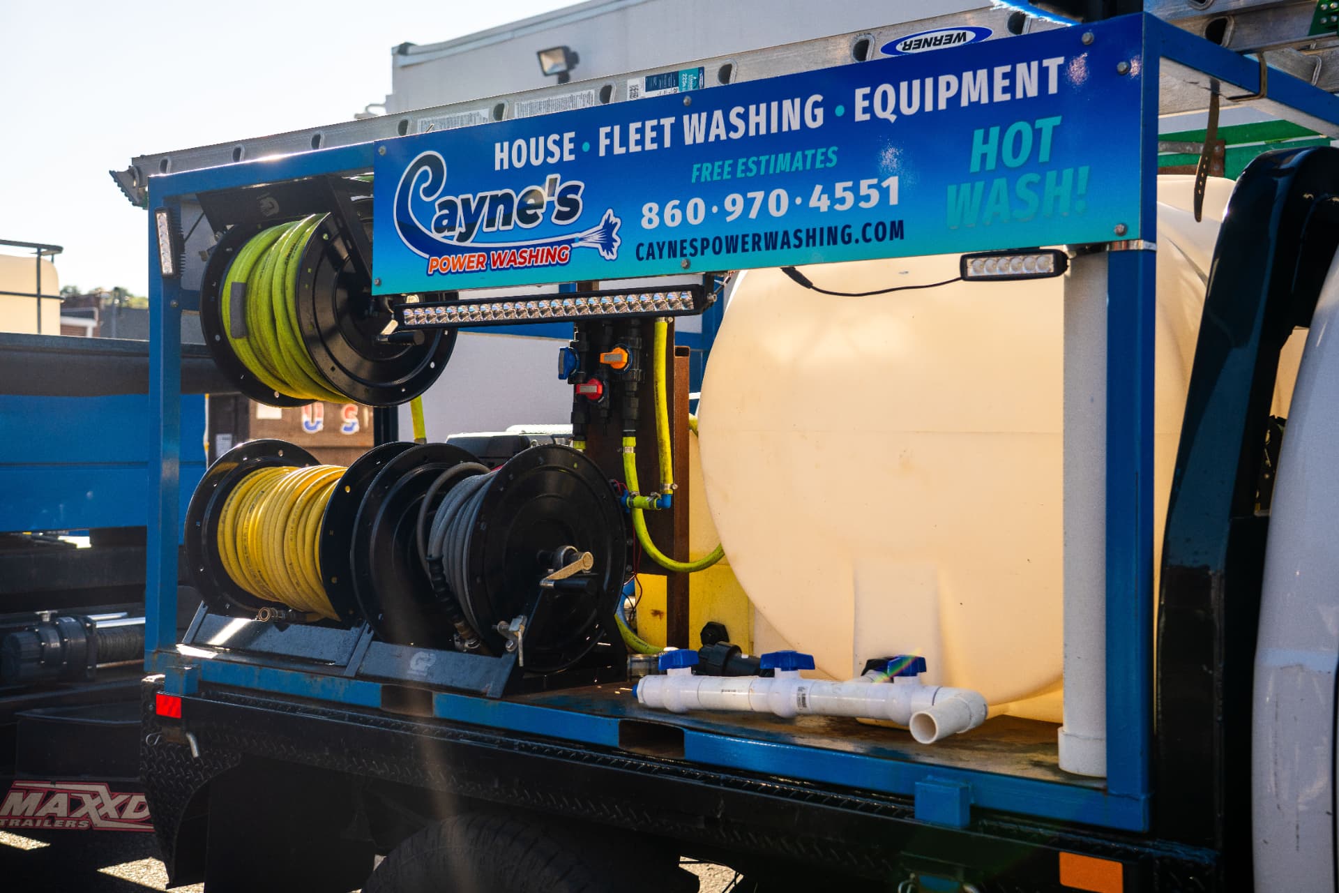 Hot wash skid with hose reels, water tank and plumbing manifold mounted on the trailer